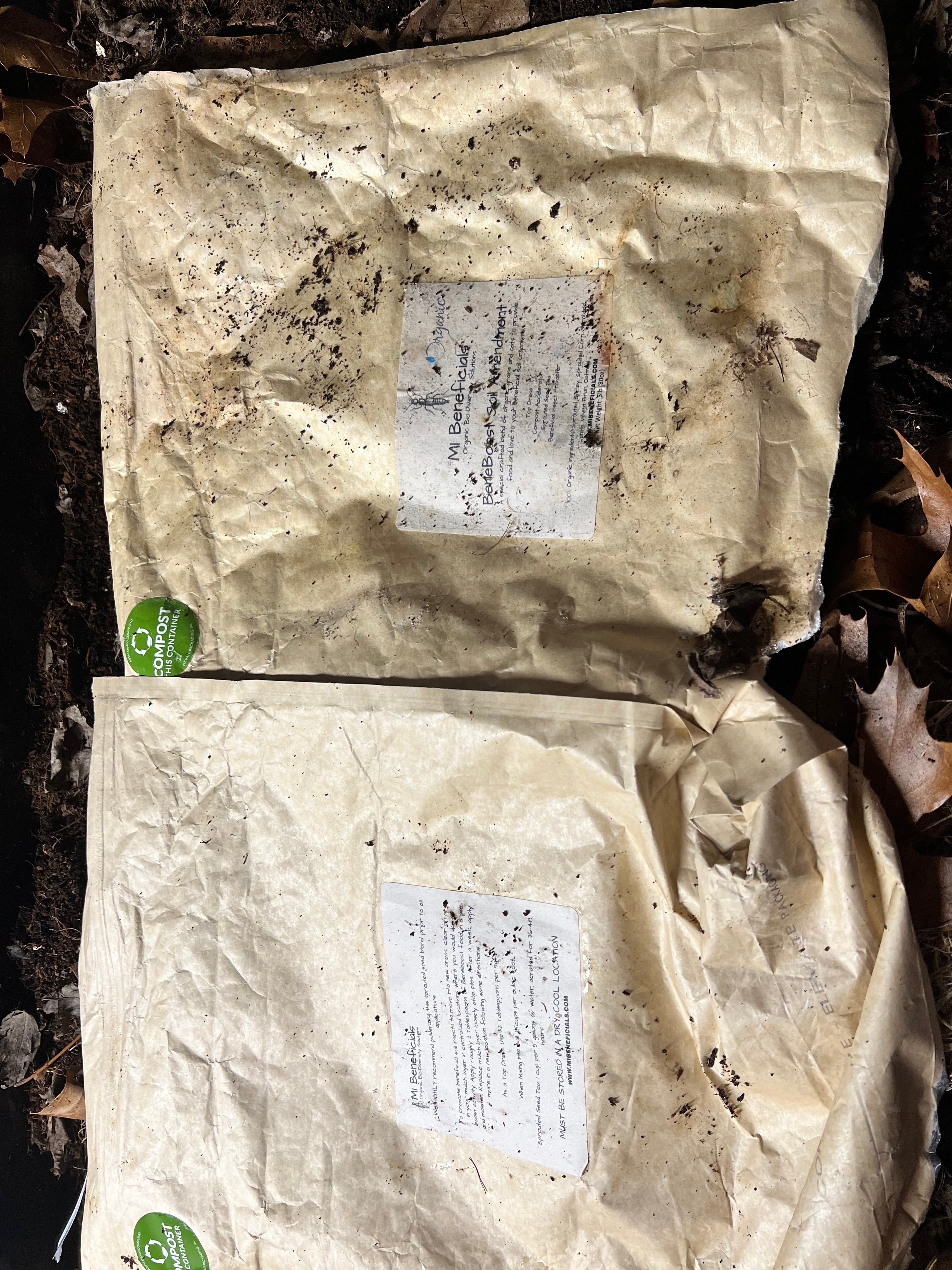 A compostable package from MI Beneficials in a vermicompost bin
